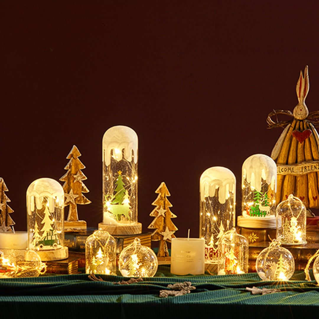 Close-up of snowy dome lamp featuring a green holiday truck, similar to a detailed white glass table lamp.