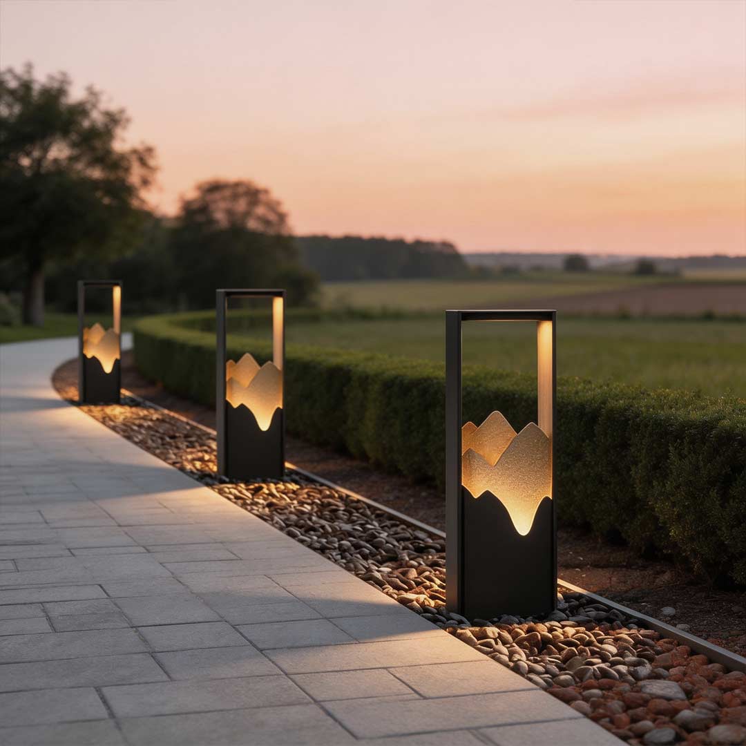 Hollow lawn lamp illuminating a modern garden pathway with elegant mountain-cut design at dusk.