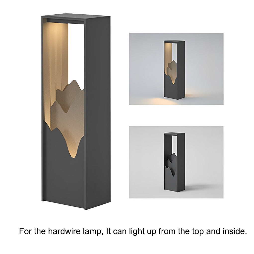 Hollow lawn lamp with mountain-cut design, providing warm illumination in a backyard.