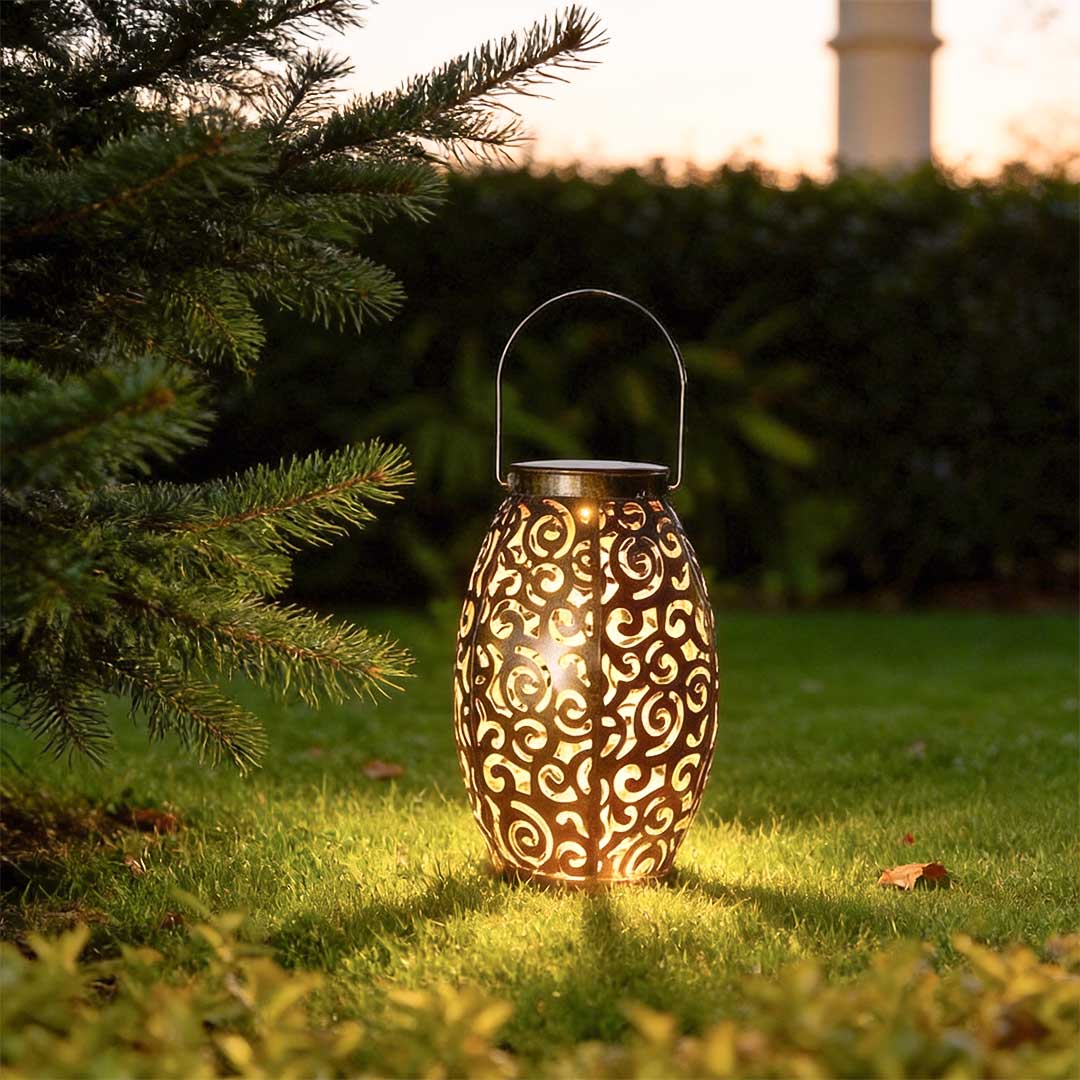 Hollow outdoor solar lights illuminating a garden pathway with a warm glow at dusk.