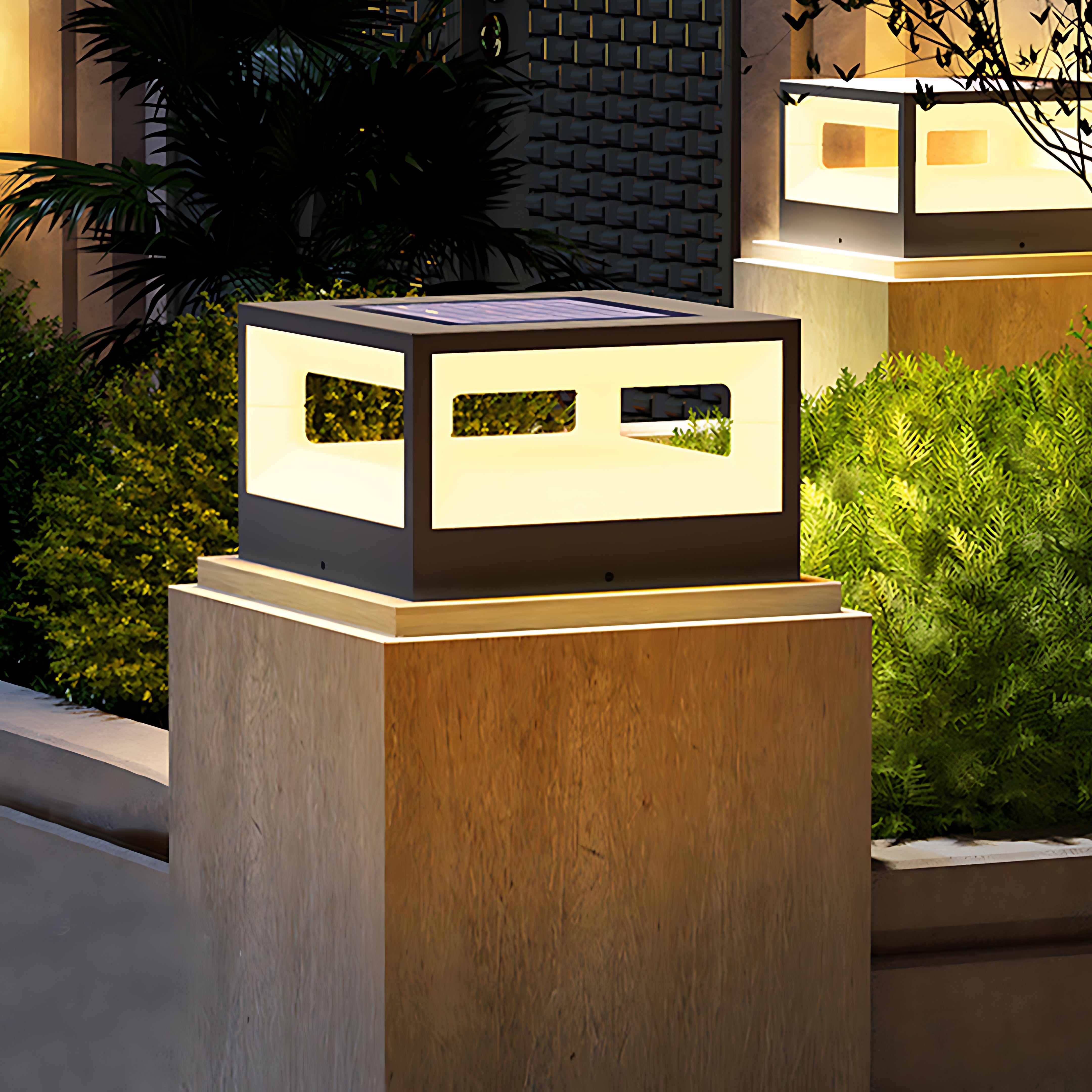 Hollow square pillar light near a garden, creating a cozy and inviting atmosphere.