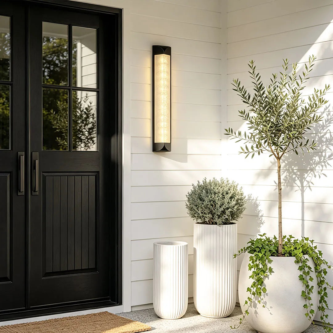 Wall sconce outdoor installed on both sides of a home entrance for symmetrical lighting.