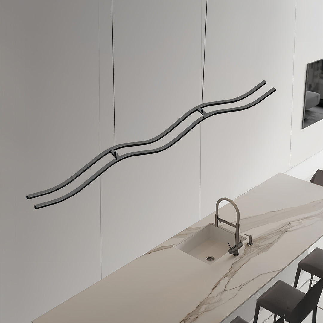 Black kitchen island pendant light mounted horizontally on a white wall, showcasing the flowing, continuous wave design and integrated LED strip.