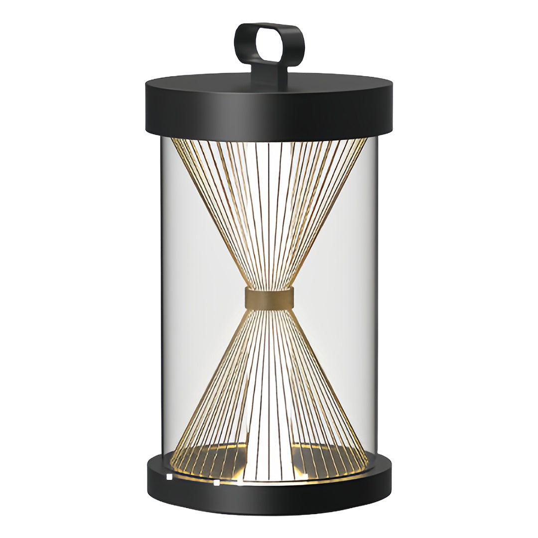 Hourglass-shaped black outdoor lantern with fine mesh interior, used as ambient accent lighting on a seaside patio lounge area.