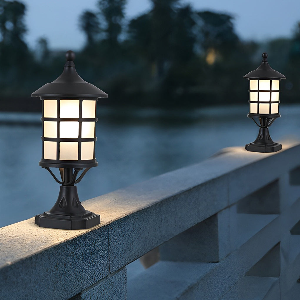 House pillar lights with a black finish, providing ambient light near a pond.