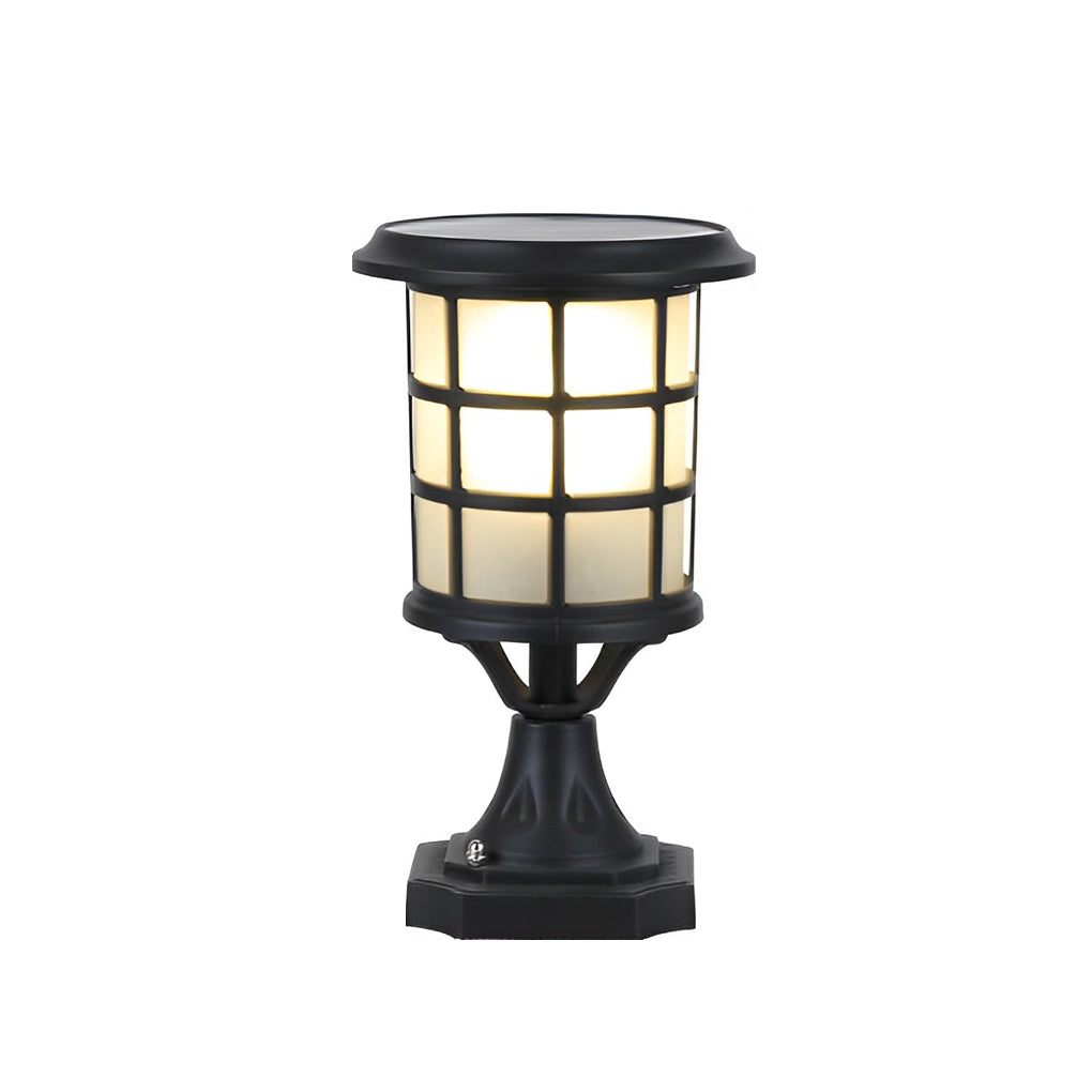 House pillar lights with a black finish, providing elegant light near a fence.