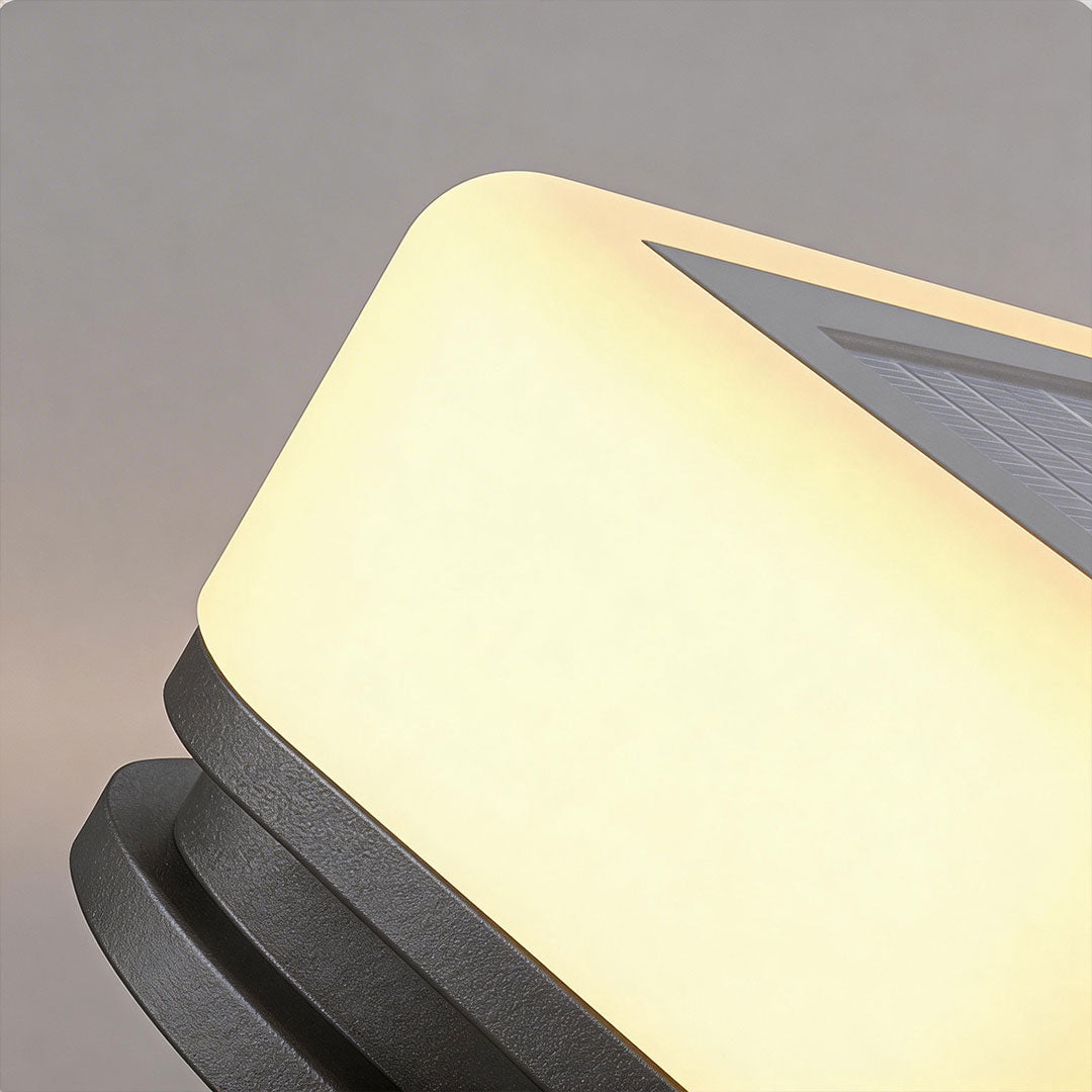 Close-up of house pillar lights with a black design and illuminated top for outdoor pathways.