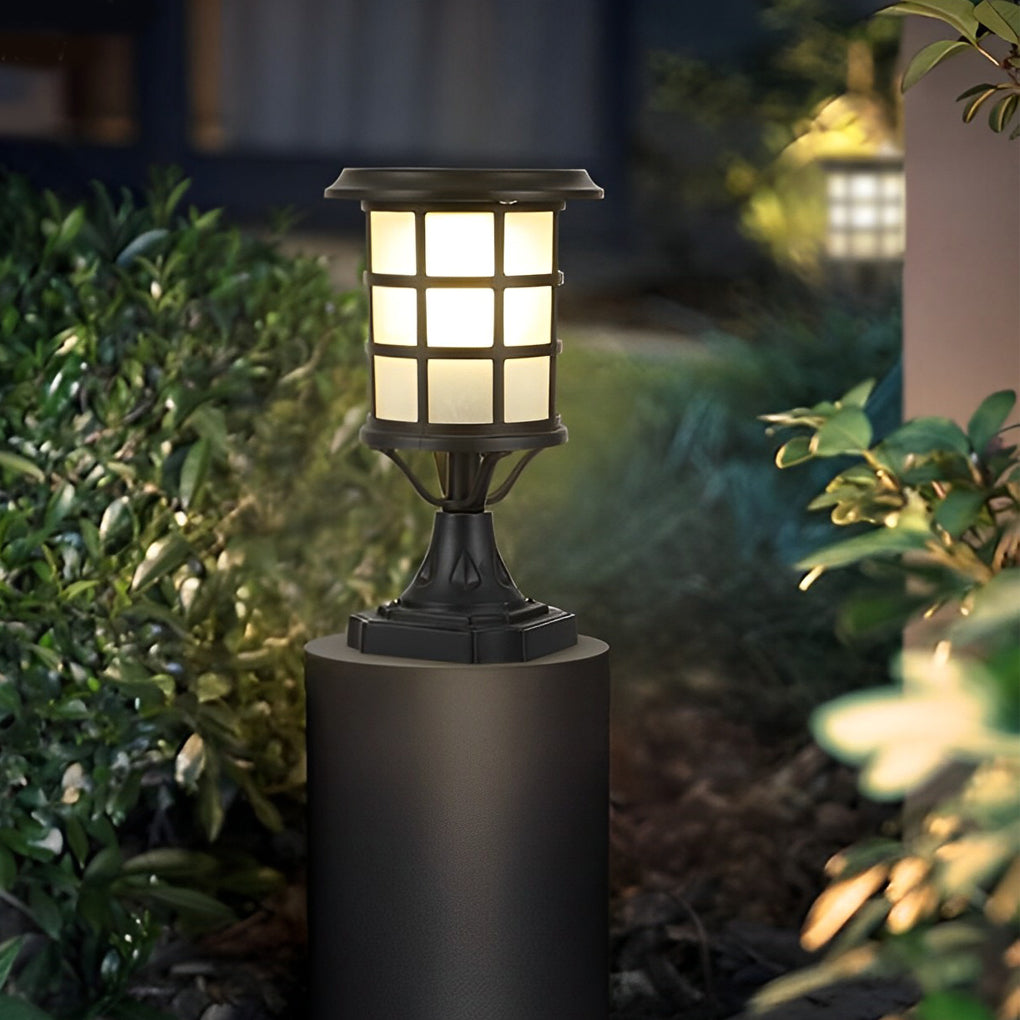 House pillar lights with a modern design, providing soft light along a pathway.