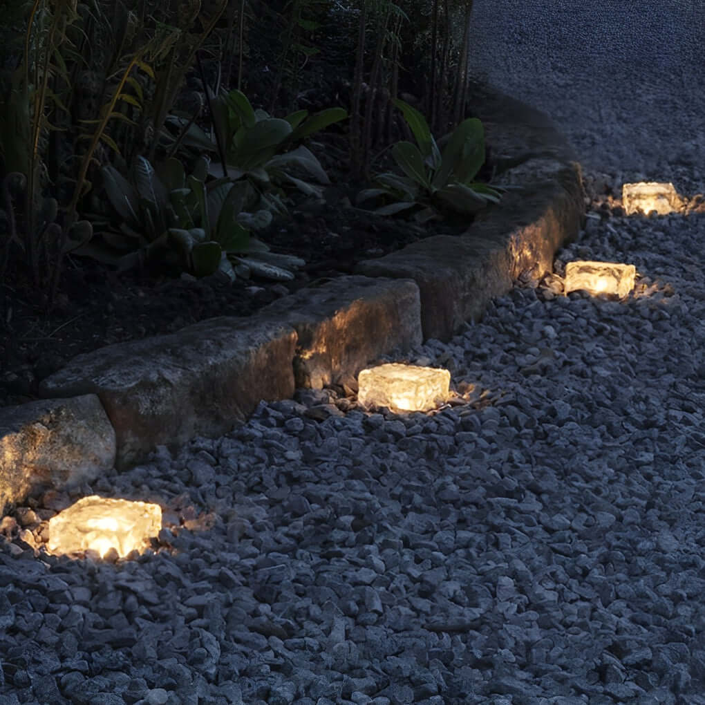 Ice cube landscape lights lining a garden path at night.