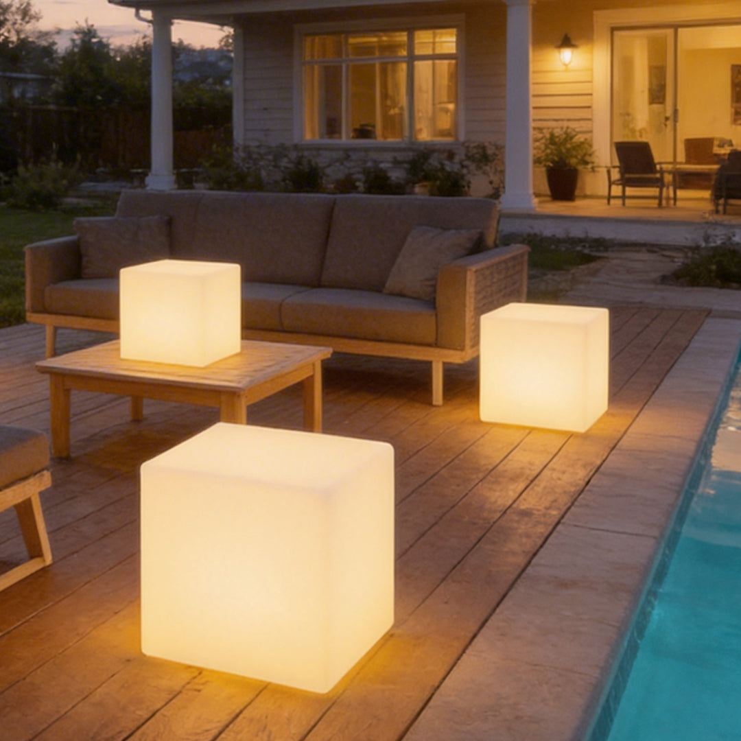 Ice cube LED lights arranged as side tables, providing ambient lighting beside a pool.