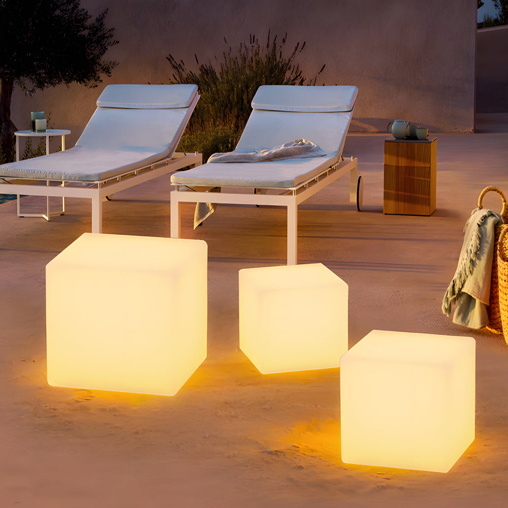 Ice cube LED lights used as stylish tables, illuminating a rooftop terrace at dusk.