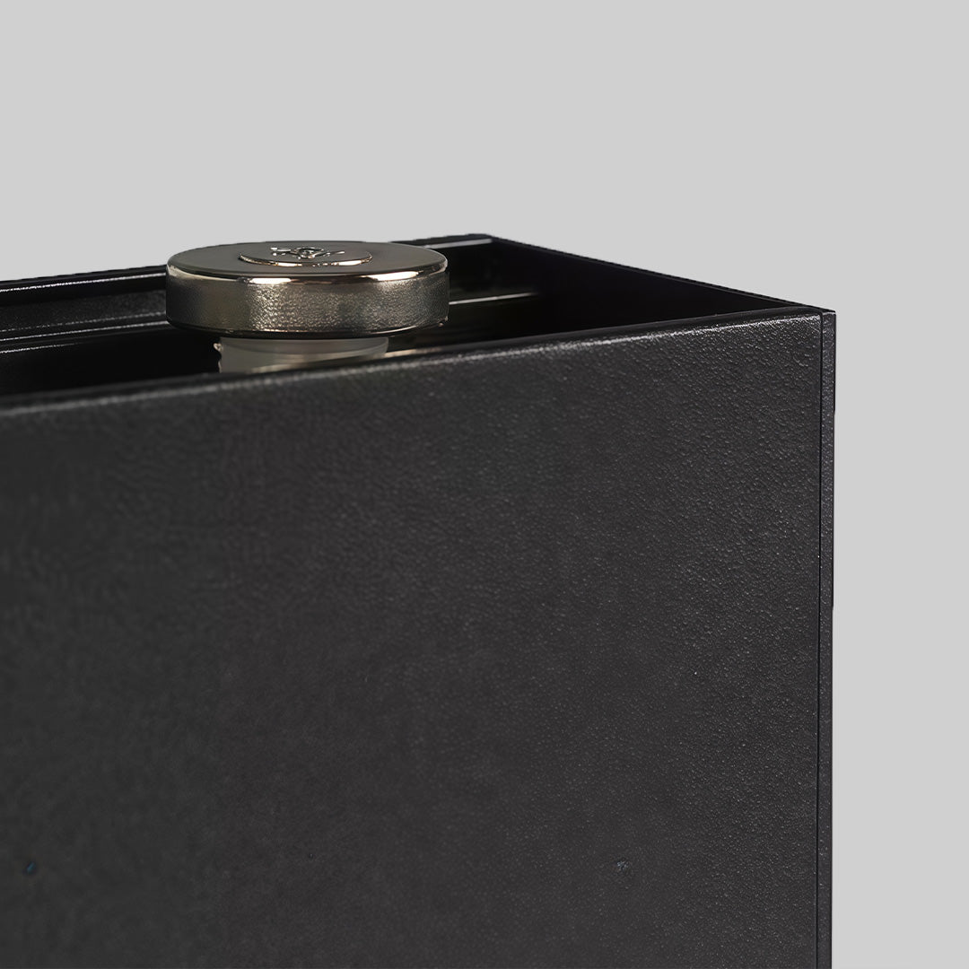 Ice cube lights embedded in rocks near garden wall.