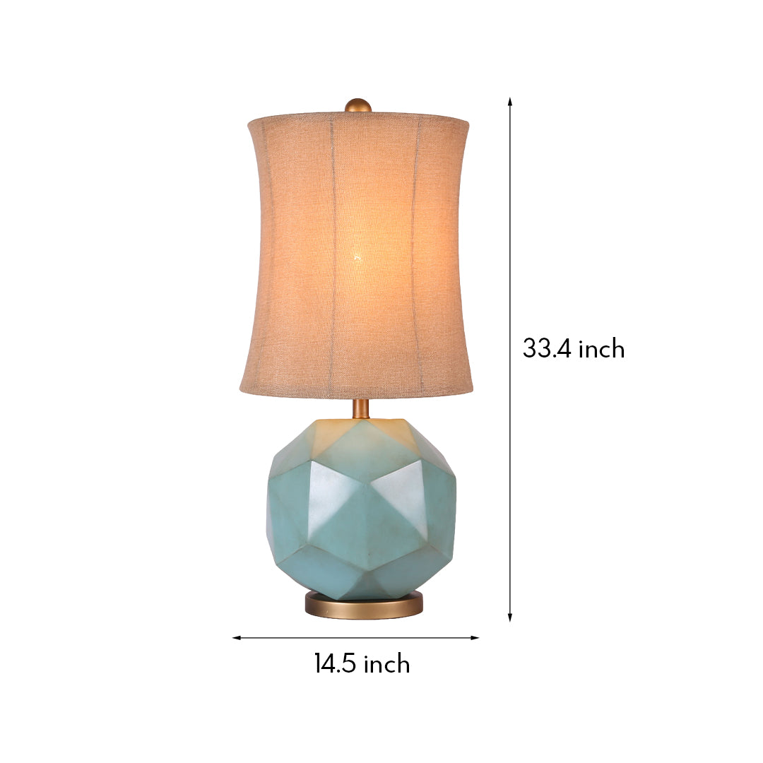 Modern industrial table lamps illuminated, highlighting the brass accents and the warm glow through the textured fabric shade.