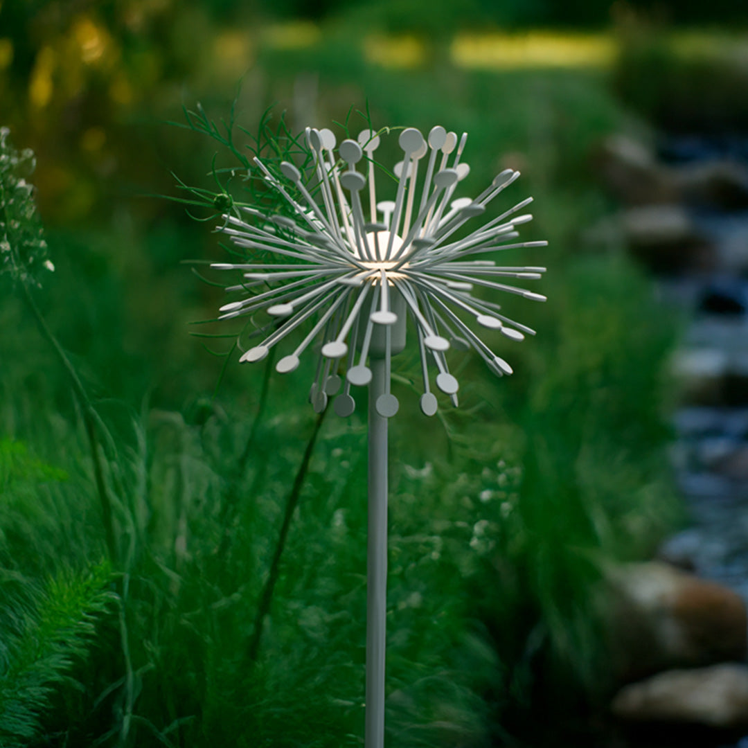 Brilliant illuminated dandelion-style landscape garden lights creating magical sparkle effect in outdoor setting