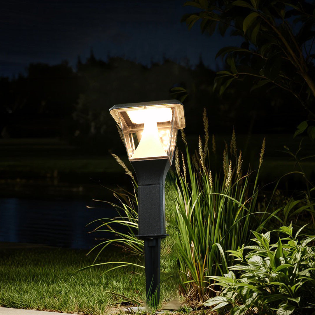 Illuminated garden light installed among greenery creating ambient outdoor lighting