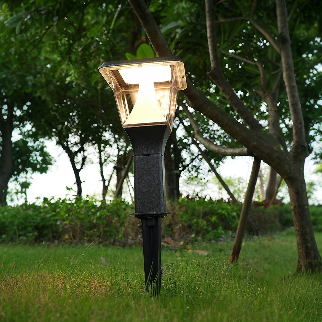 Illuminated garden light installed among greenery creating ambient outdoor lighting