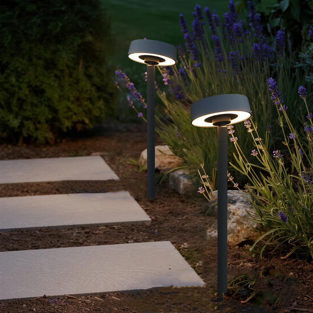 Warm illuminated landscape outdoor lights along stepping stone pathway showcasing beautiful nighttime garden lighting design