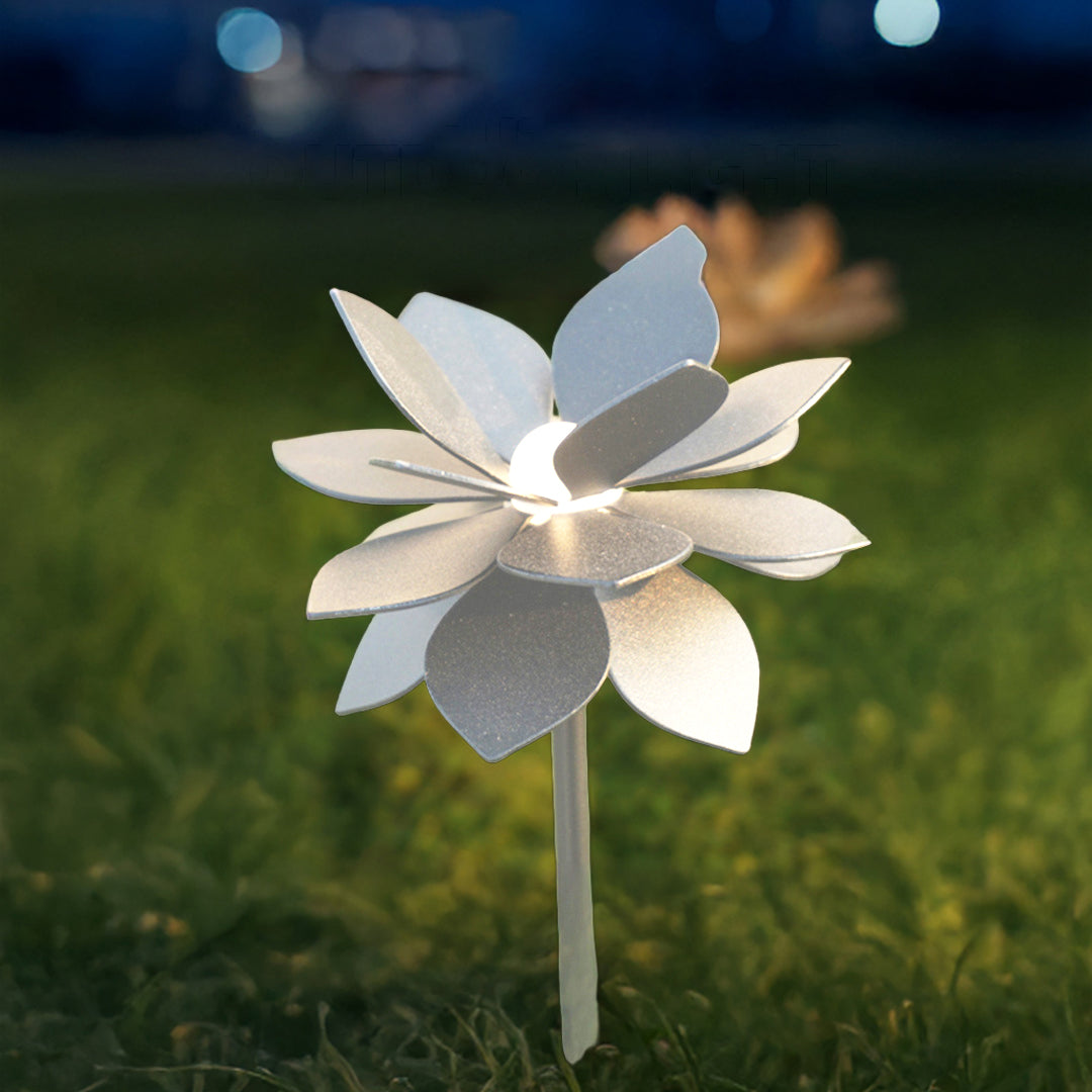 Illuminated lotus-style landscape garden light with soft white glow creating magical nighttime garden atmosphere