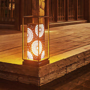 LED bollard light illuminating a garden path, offering a stylish design with geometric cutouts.