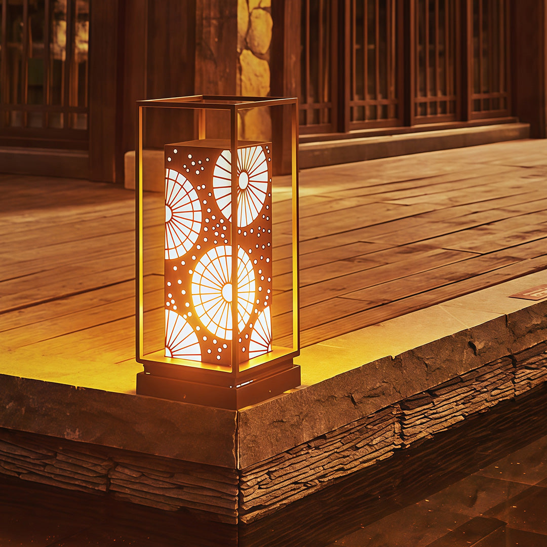LED bollard light illuminating a garden path, offering a stylish design with geometric cutouts.