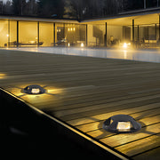 In-ground low voltage landscape lighting installed along a modern walkway, providing subtle illumination for outdoor pathways