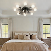 Indoor ceiling fans with lights featuring a modern black design, illuminating a cozy bedroom.