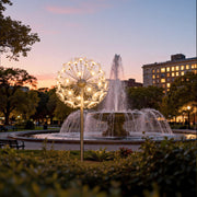 Large indoor installation of glowing dandelion garden lights outdoor style.