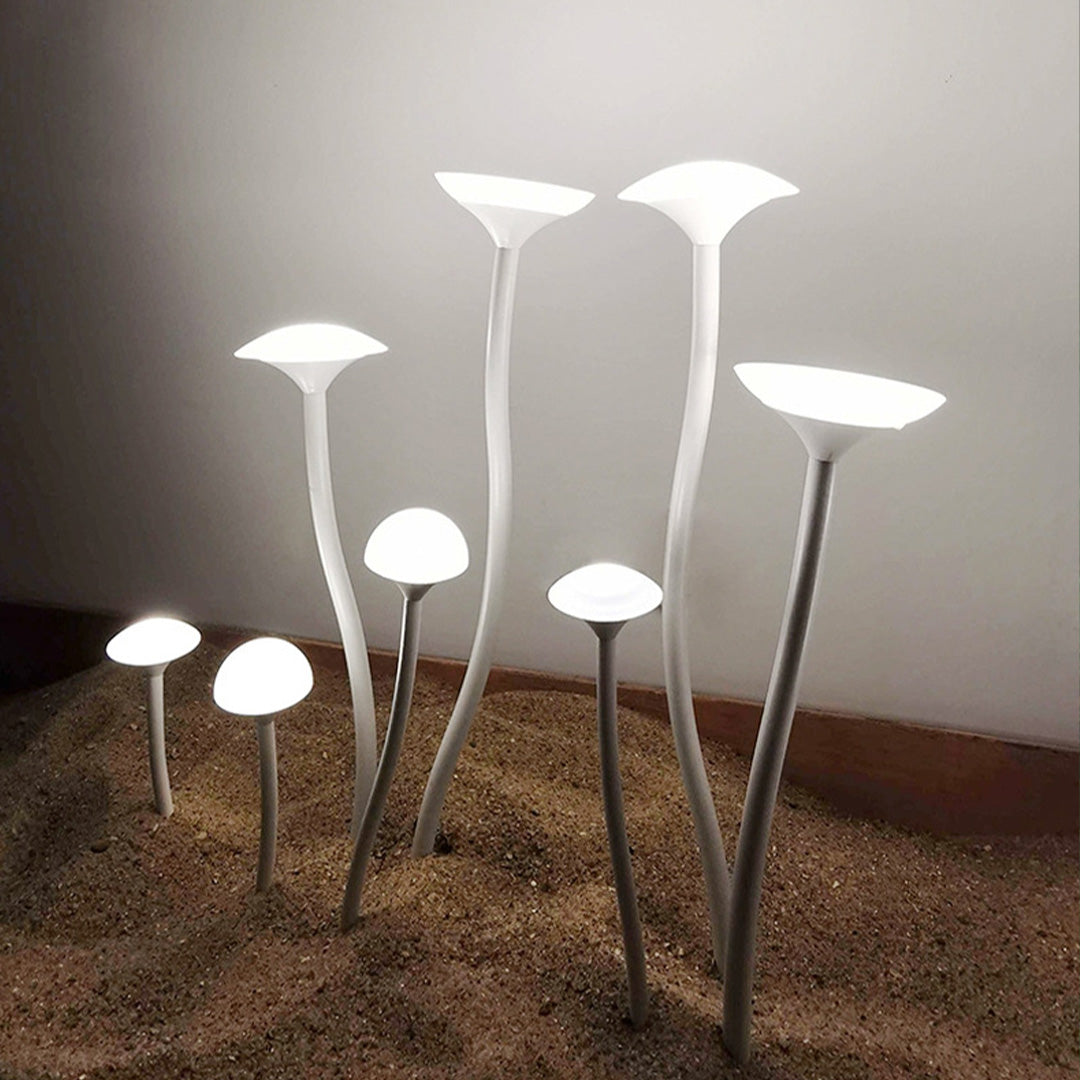Indoor display of illuminated mushroom-style garden lights landscape showing warm white LED light output