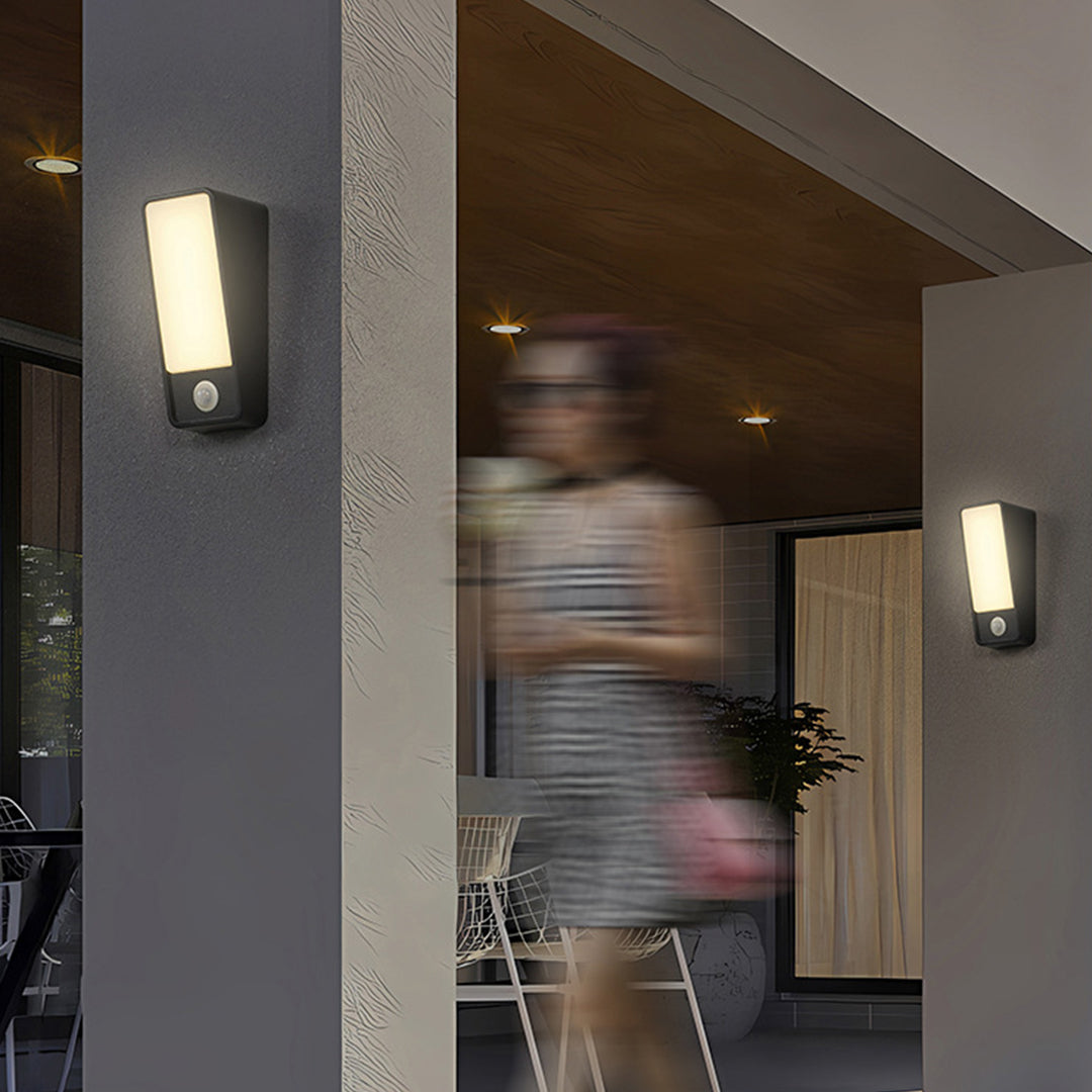 Indoor motion sensor lights installed in modern hallway with person passing by