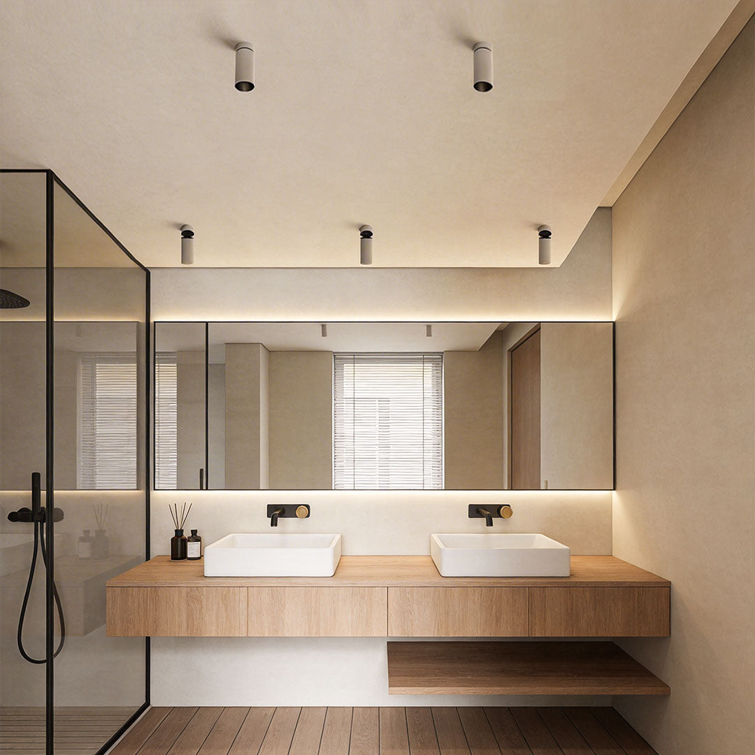 Indoor spotlight lamp in a modern bathroom with a white marble countertop and minimalistic design.