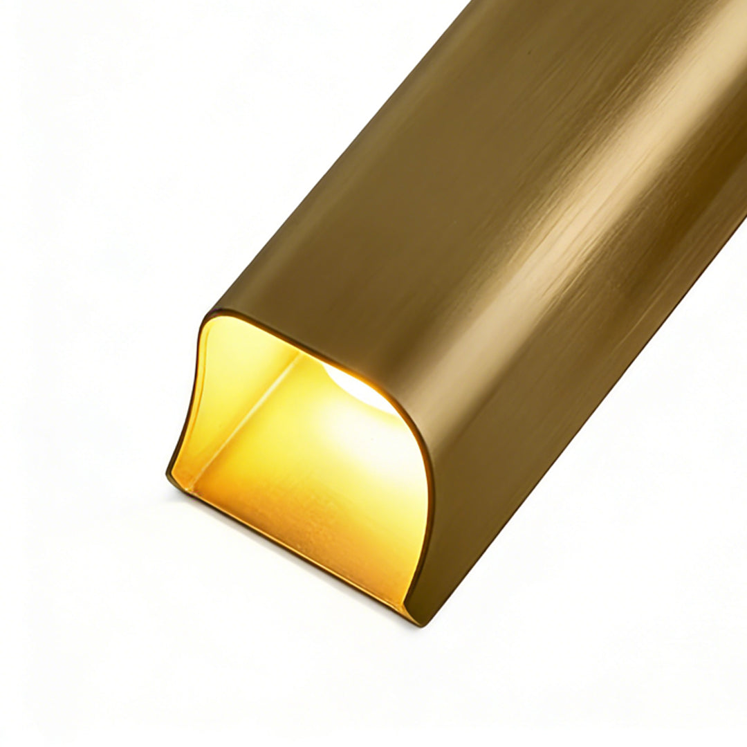 Close-up of brass wall light indoor spotlight lamp showing curved design and warm glowing interior finish.