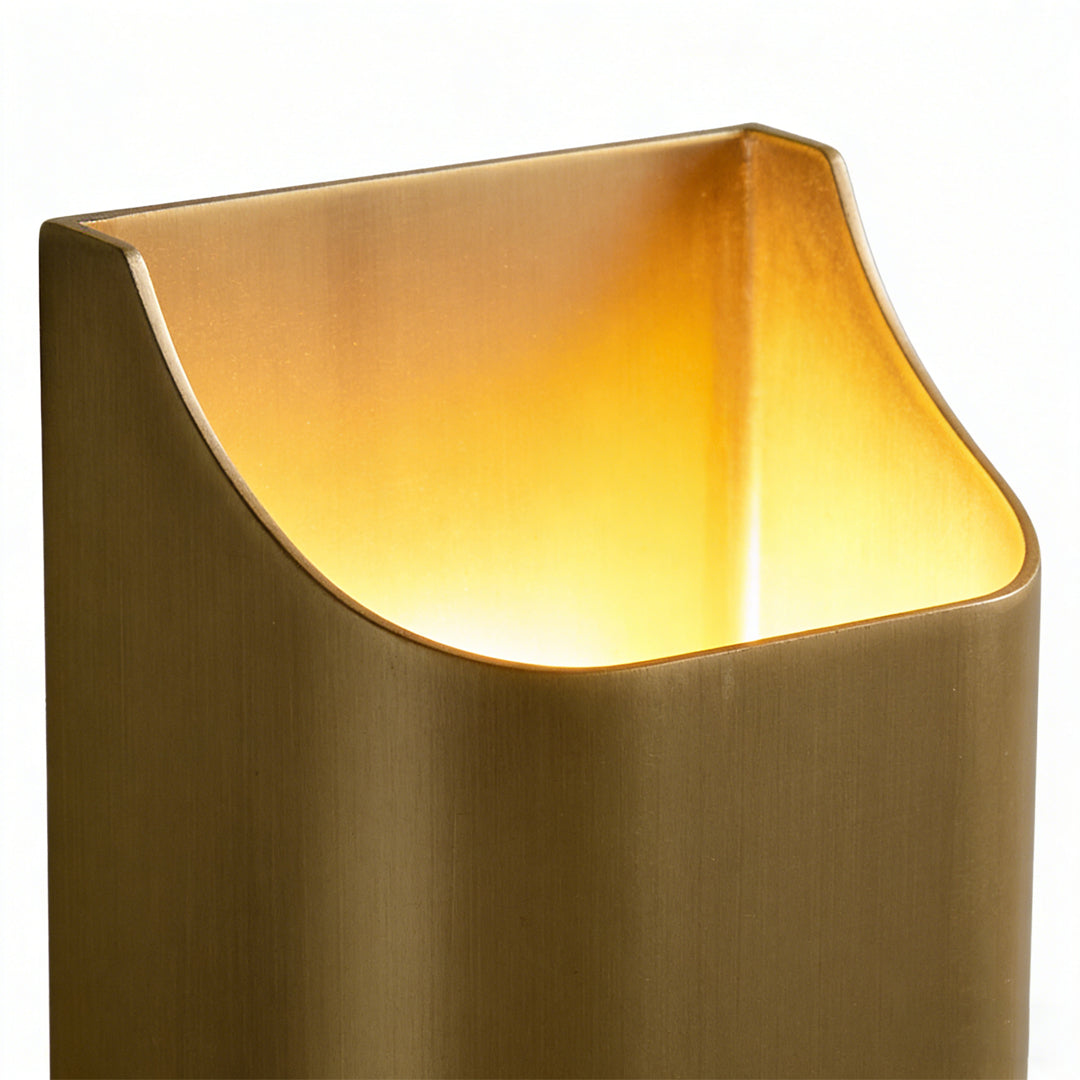 Detailed view of brass wall light indoor spotlight lamp highlighting smooth metallic surface and soft light output.