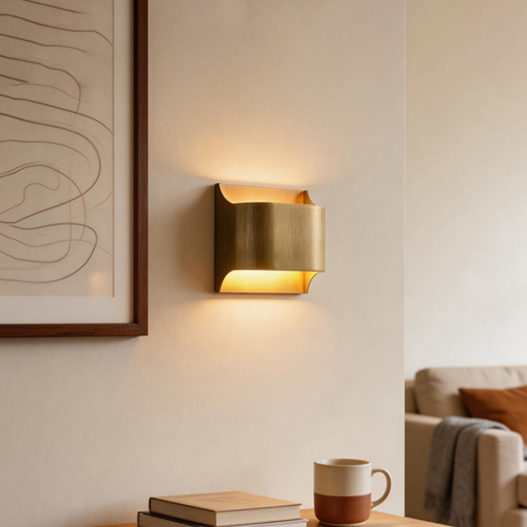 Modern living space with brass wall light indoor spotlight lamp beside framed art creating cozy lighting effect.