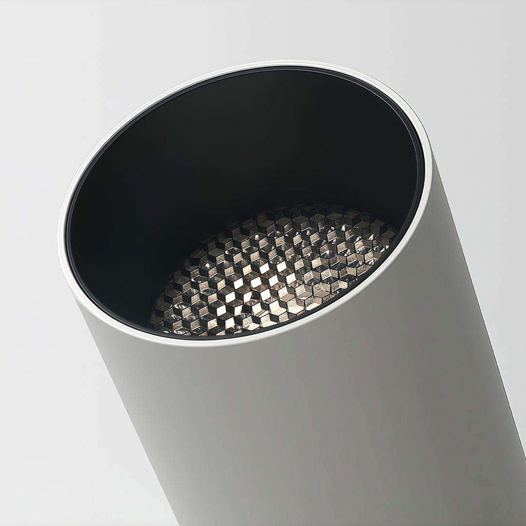Close-up view of an indoor spotlight lamp showing its sleek cylindrical design with a detailed light lens.