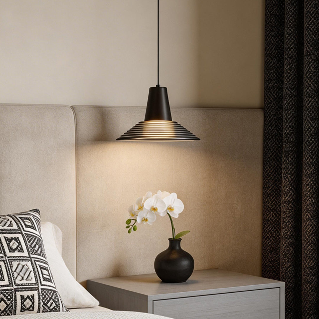 Minimalist bedroom featuring glass cone pendant light indoor spotlight lamp beside bed with warm lighting.