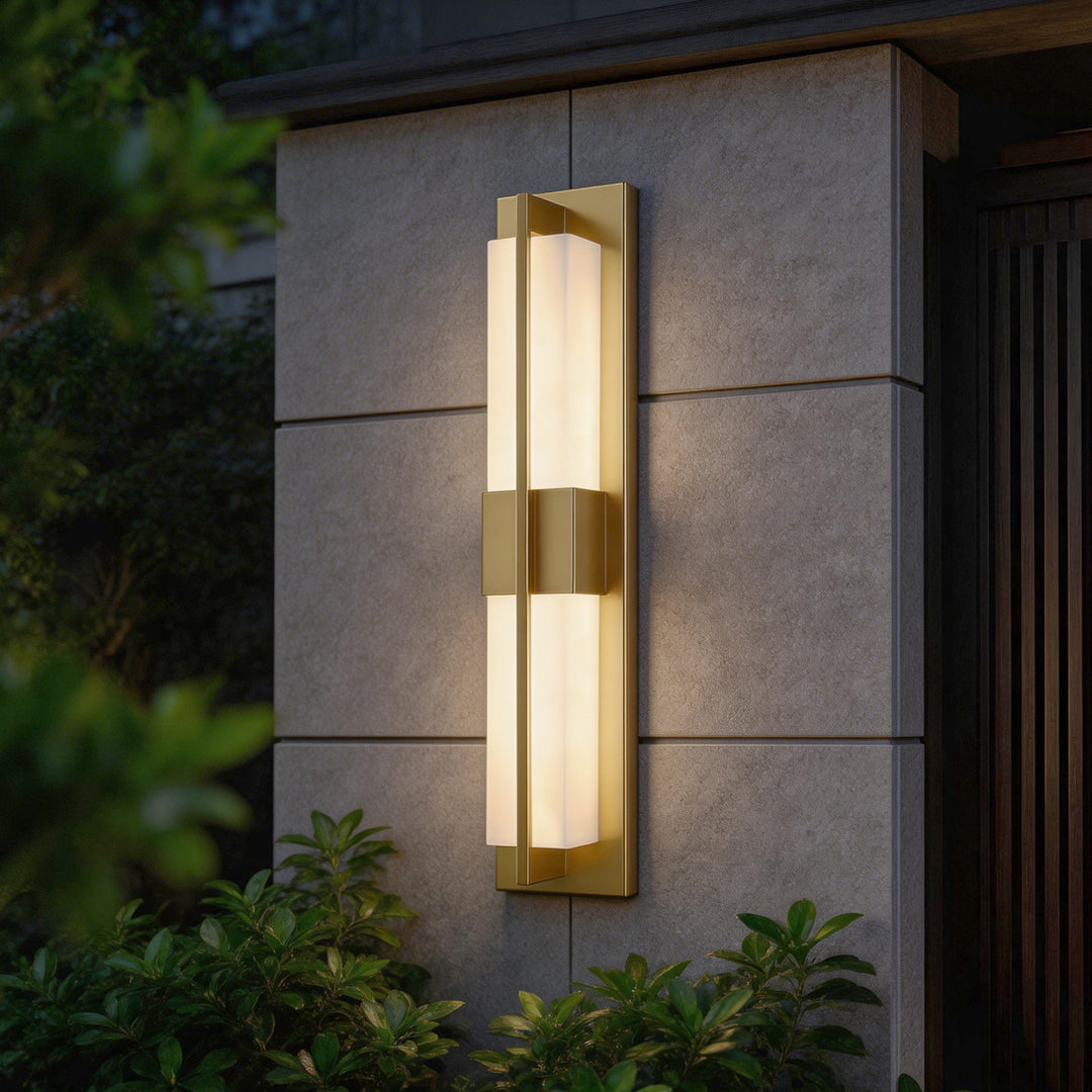 Exterior wall with gold wall lighting indoor spotlight lamp illuminating entryway with warm elegant glow.