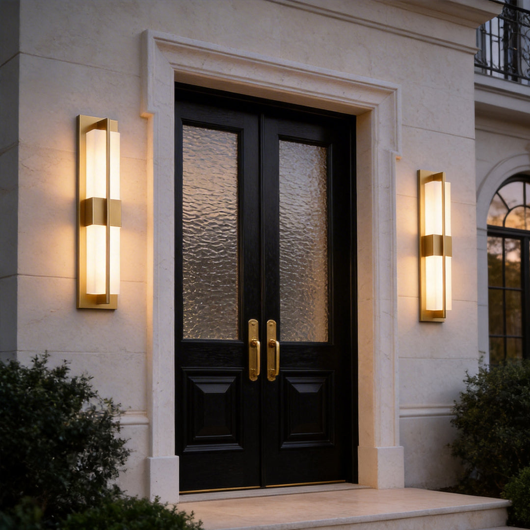 Front door area with gold wall lighting indoor spotlight lamp adding symmetry and warm welcoming illumination.