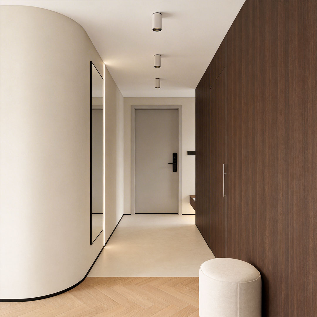 Indoor spotlight lamp mounted on the ceiling in a contemporary hallway with white walls and natural light.