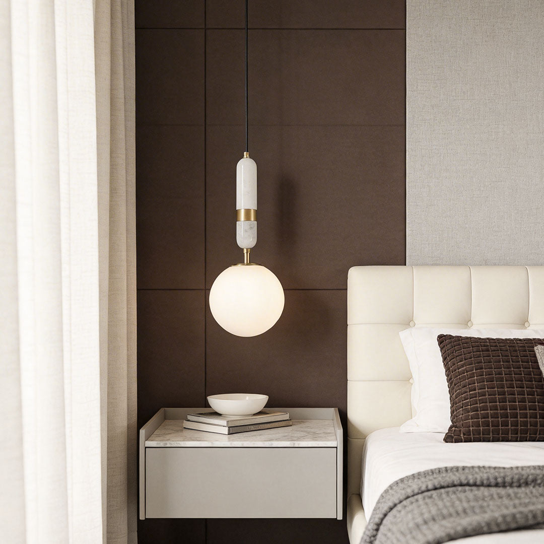 Minimalist bedroom corner with modern globe pendant light indoor spotlight lamp adding warm ambient lighting.