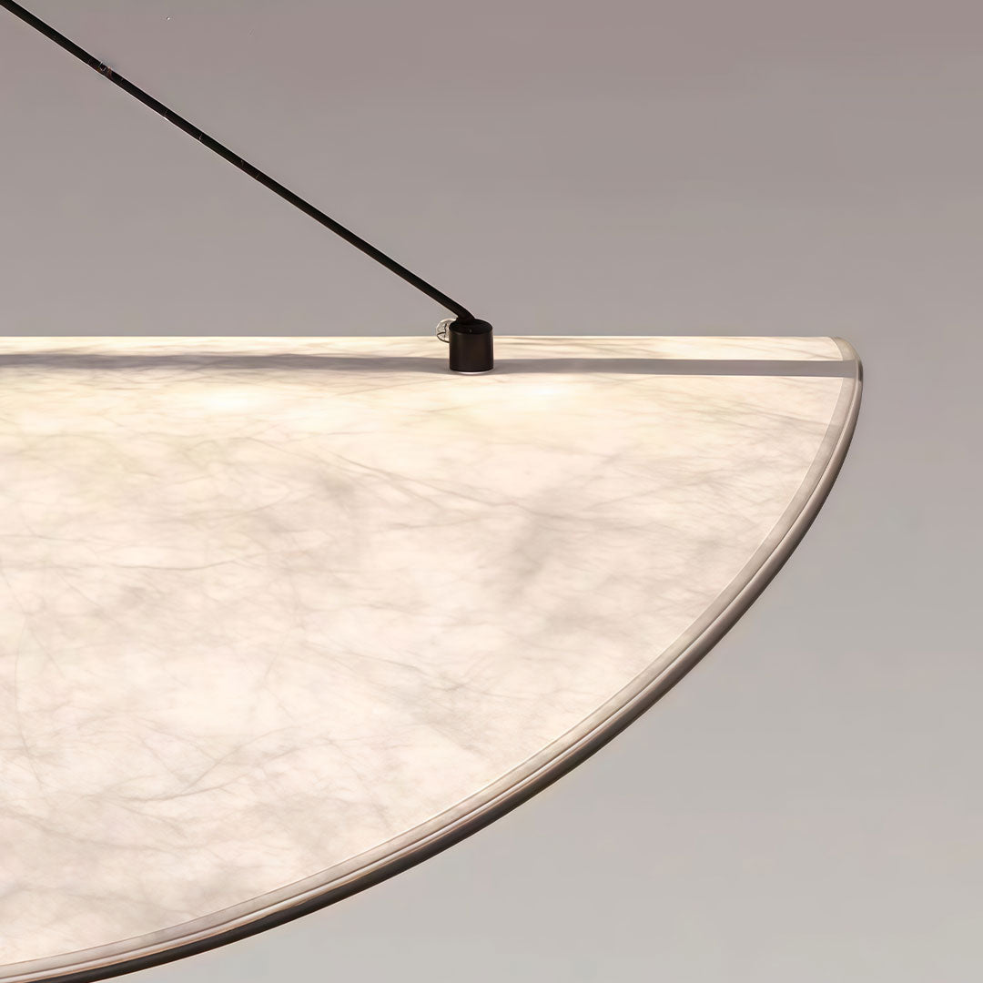 Detailed view of oversized chandeliers indoor spotlight lamp edge with fabric texture and subtle lighting.