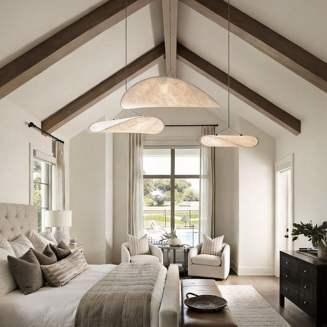 Spacious bedroom featuring oversized chandeliers indoor spotlight lamp creating warm ambient lighting.