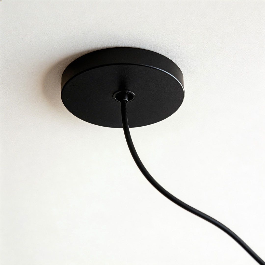 Close-up of paper pendant light fixtures indoor spotlight lamp showing ribbed paper texture and warm light.