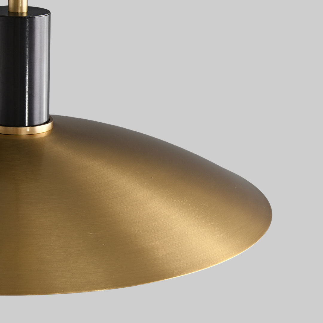 Close-up of vintage glass light pendant indoor spotlight lamp with brass dome shade and exposed bulb.