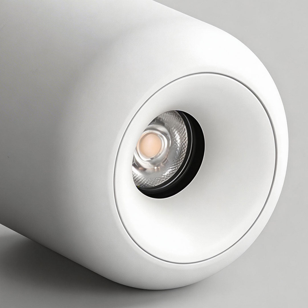 Close-up view of a white cylindrical indoor spotlight lamp showing the detailed light lens.