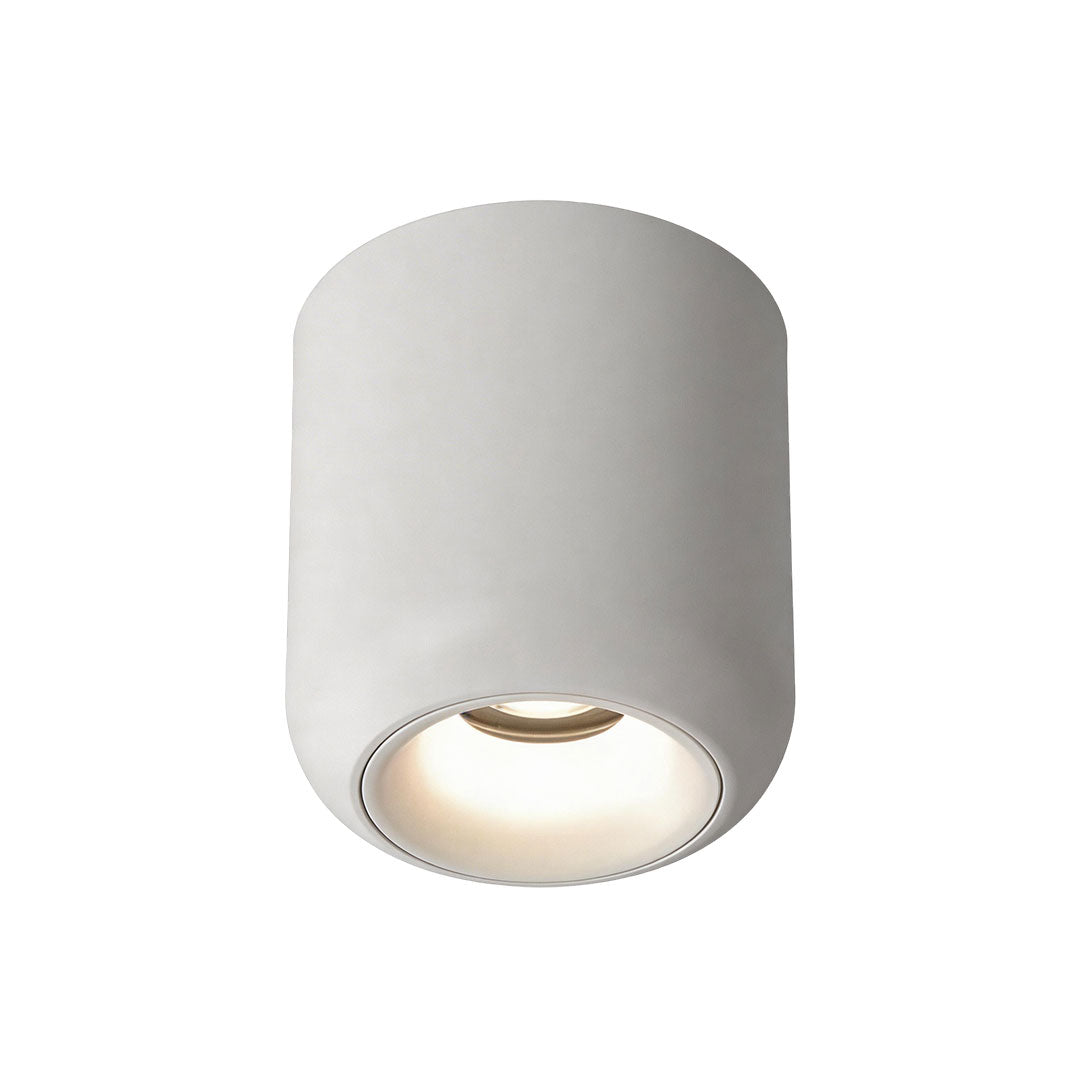 Cylindrical white indoor spotlight lamp with a clean minimalist design and a visible light lens.