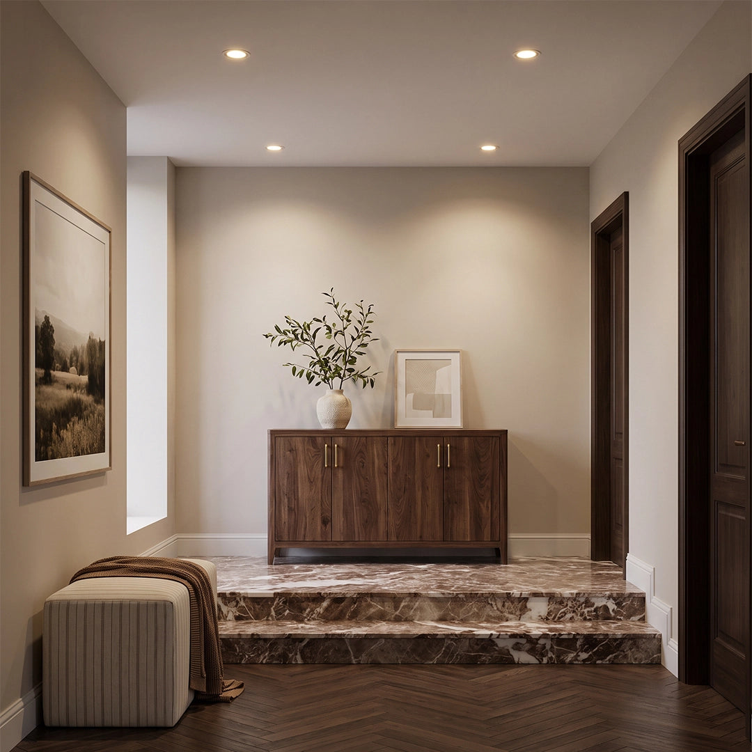 Indoor spotlights illuminating an entryway with a sideboard, floral vase, and wall art.