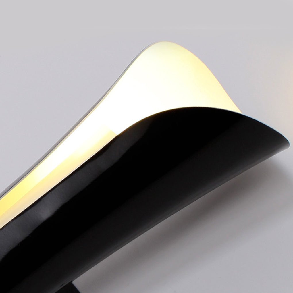 Close up detail of indoor up down wall lights showing curved metal housing and LED strip.