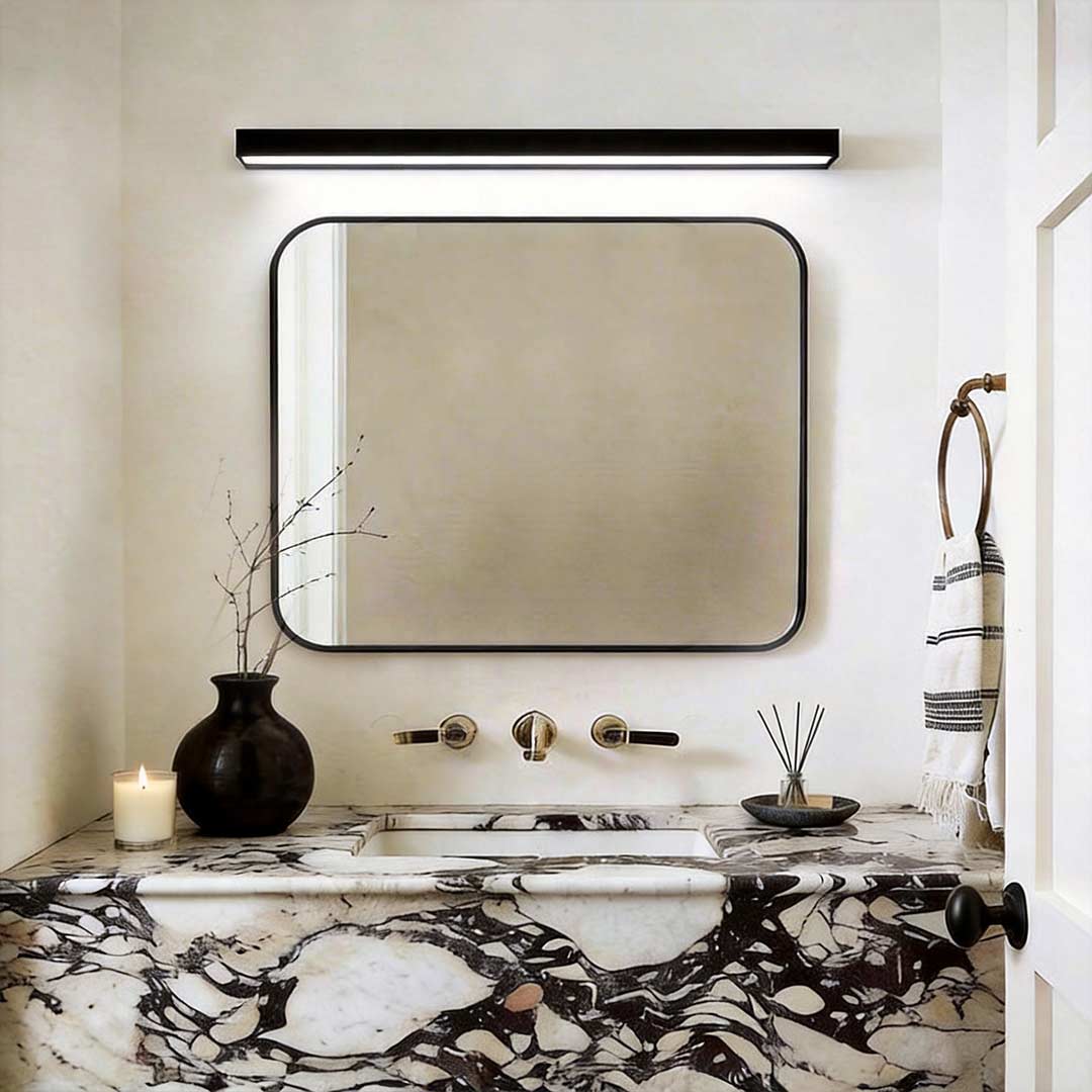 Indoor wall washer light illuminating a modern bathroom mirror with warm even glow.