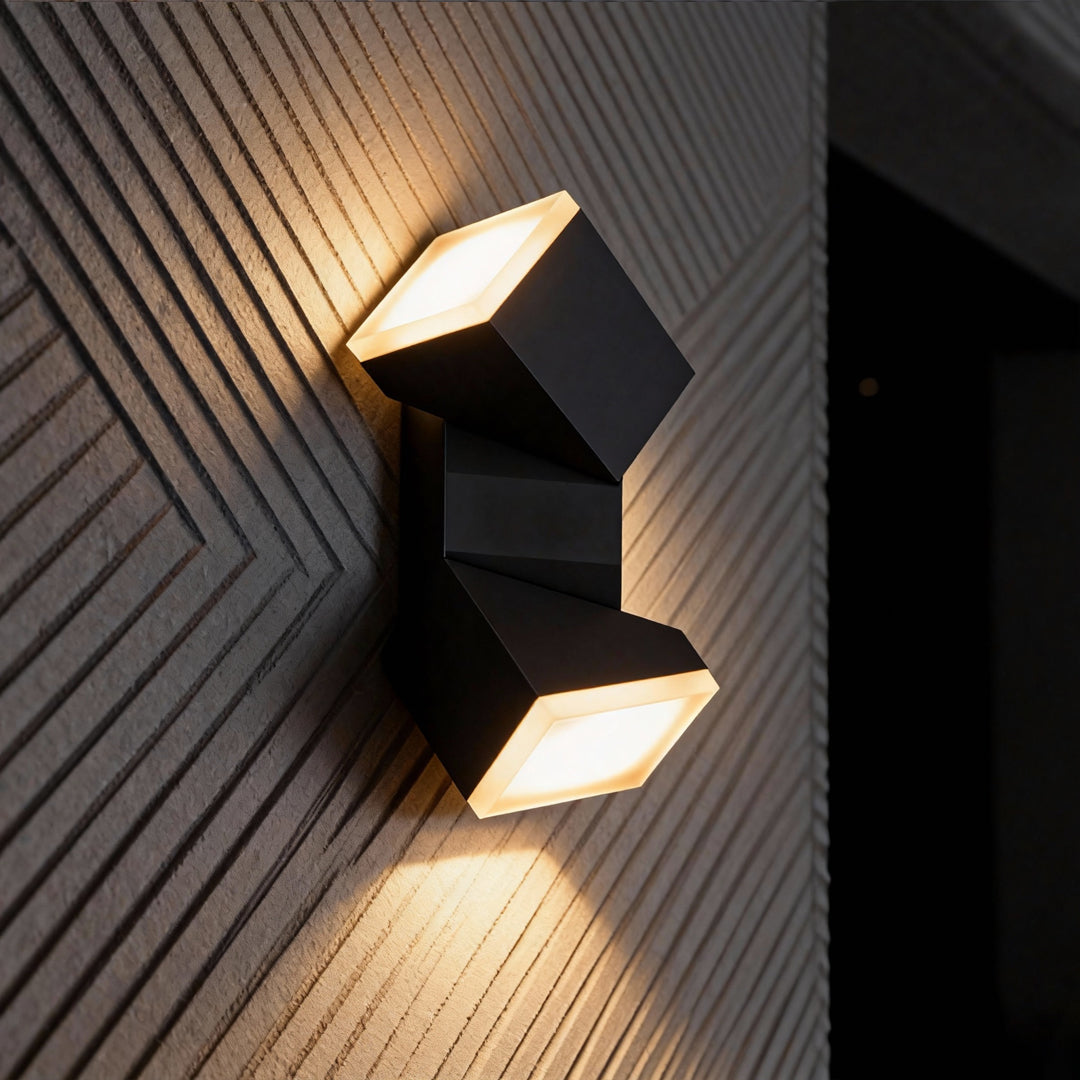 Black modern outdoor wall fixture on a textured wall, emitting bright dual beams similar to industrial bollard lights.