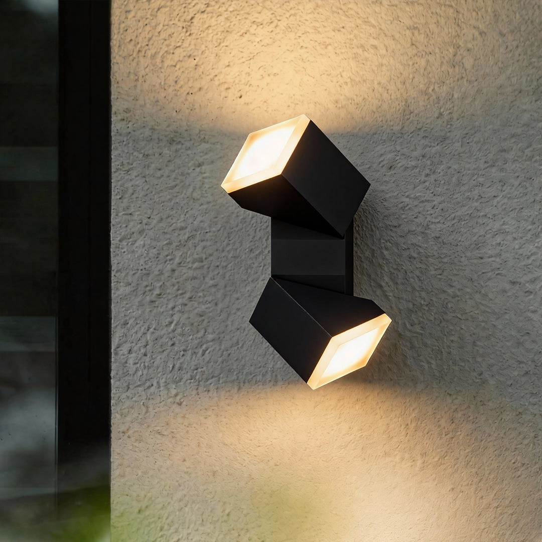 Black outdoor wall light mounted on a vertical surface, casting symmetrical up-and-down beams reminiscent of industrial bollard lights.